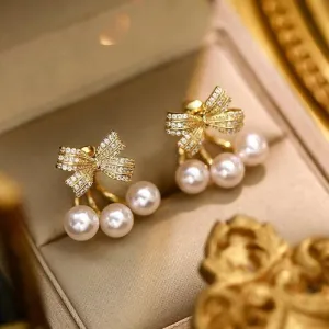 Pinapes crystal studded bow shaped stud pearl drop earrings for women