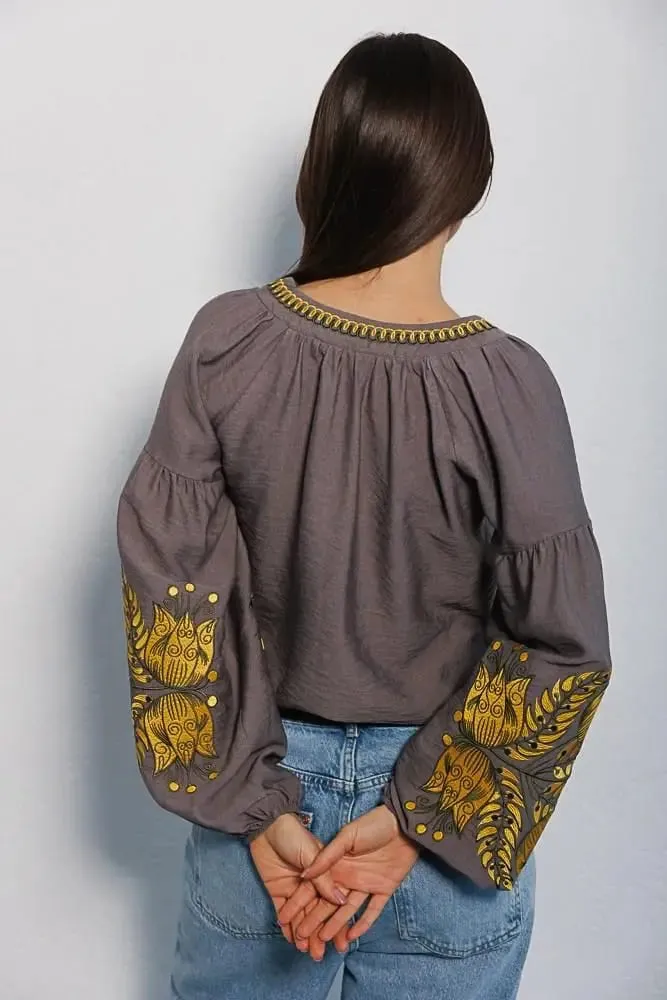 Women's embroidered blouse in graphite color with smooth floral patterns on the sleeves