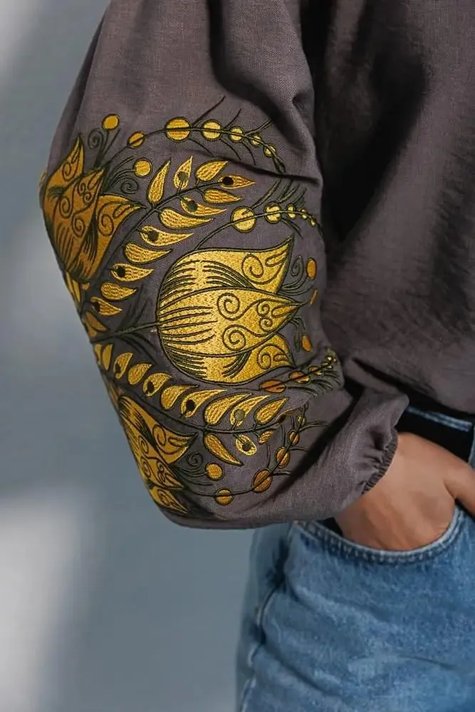 Women's embroidered blouse in graphite color with smooth floral patterns on the sleeves